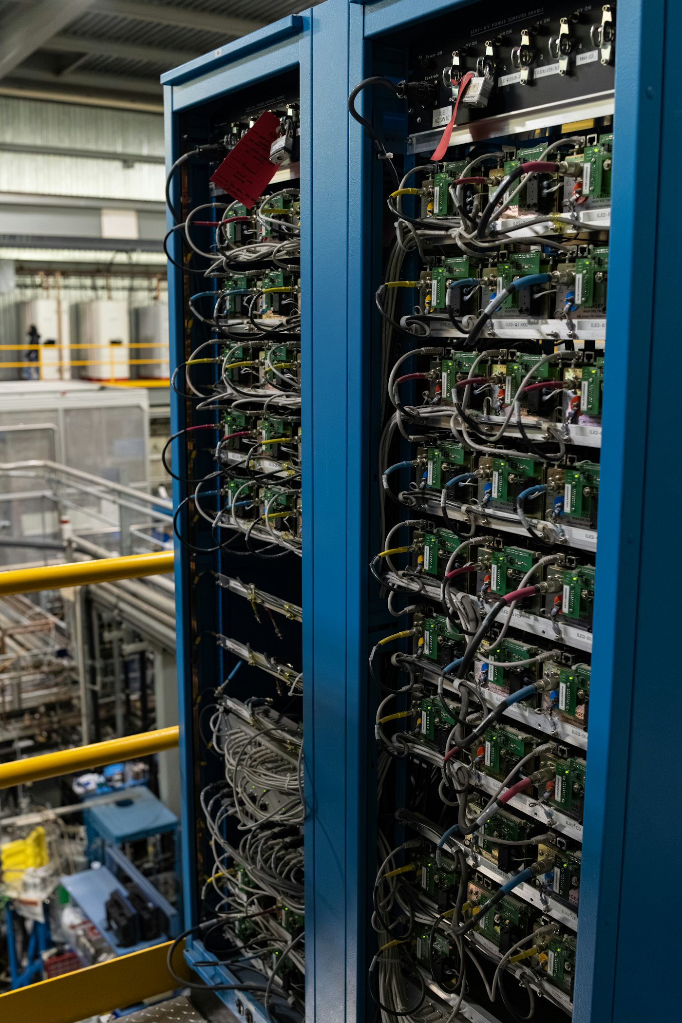 Two server racks filled with electronic components and wires